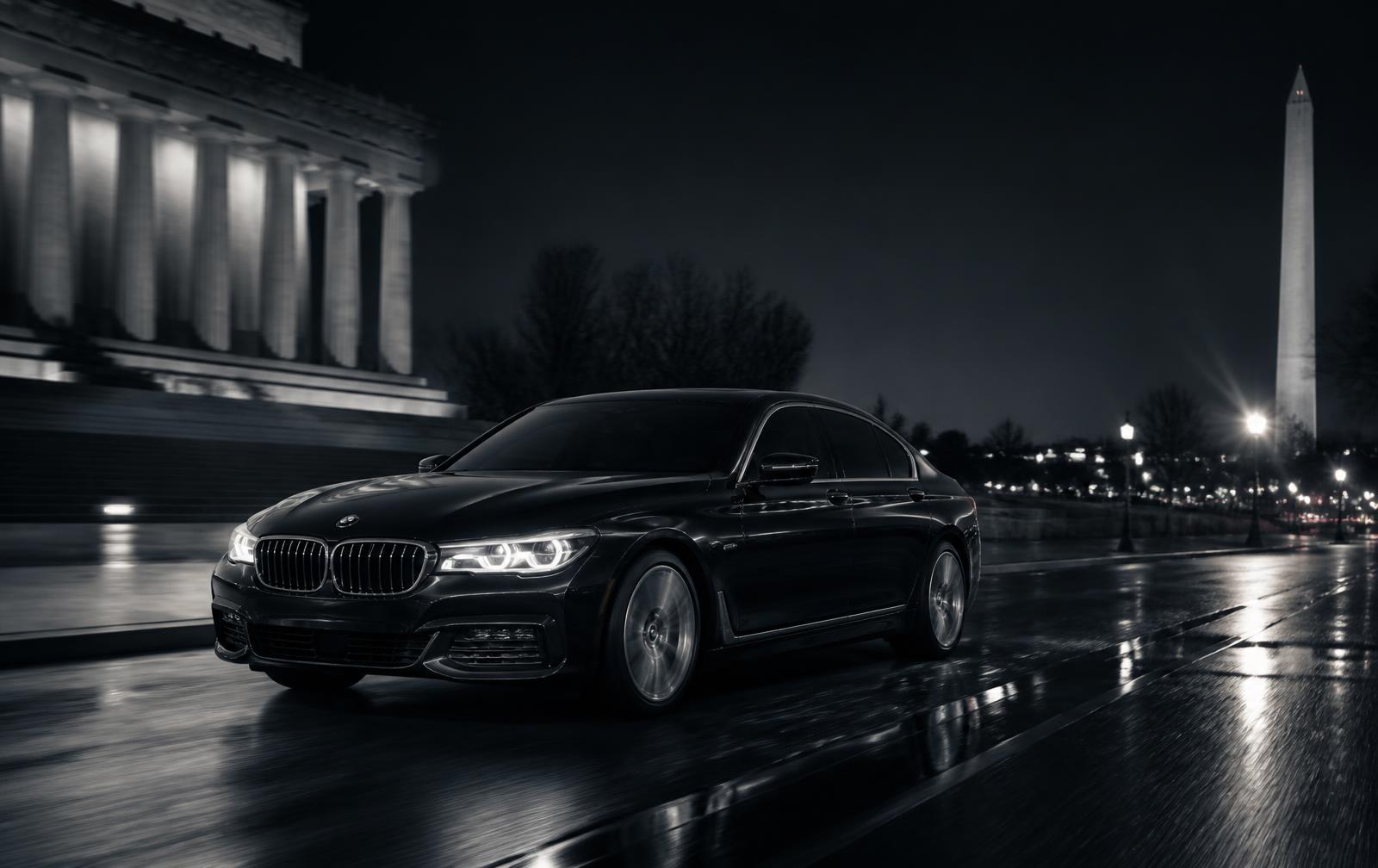 Black executive sedan passing the Lincoln Memorial on a wet night in Washington DC